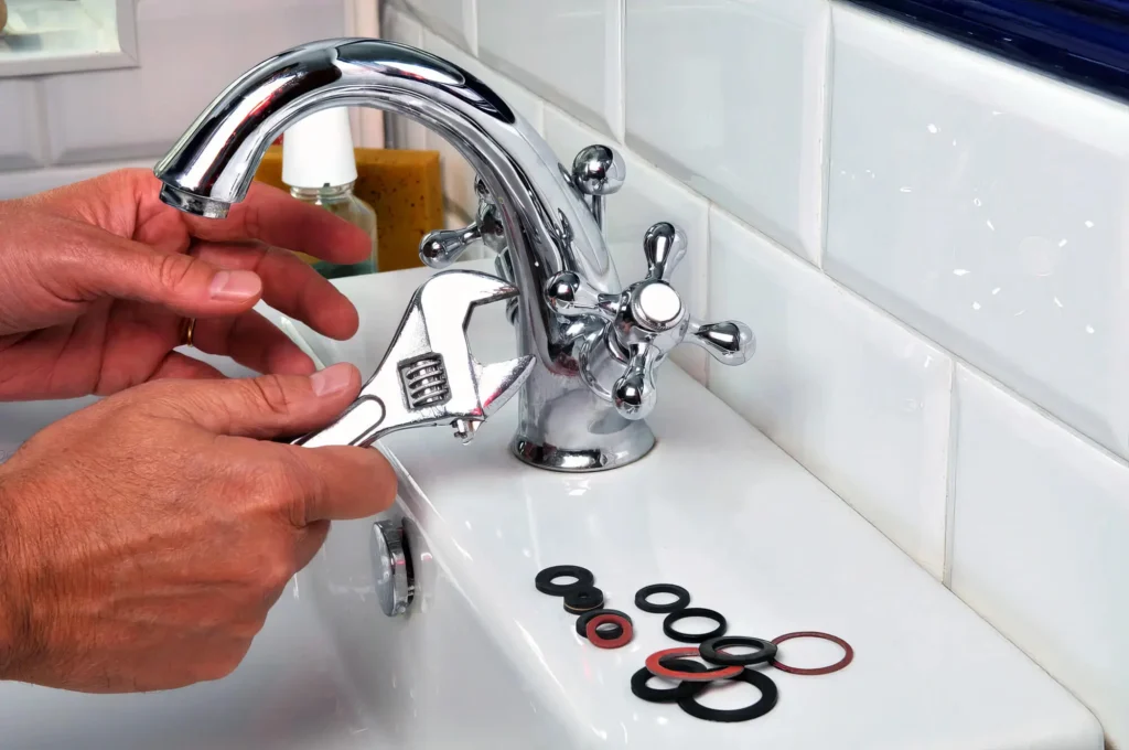 Plumber performing maintenance on a bathroom faucet in Coconut Creek