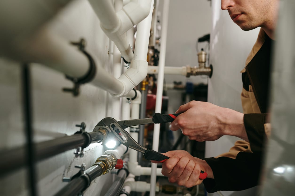 Plumbers maintaining commercial plumbing pipes in Coconut Creek