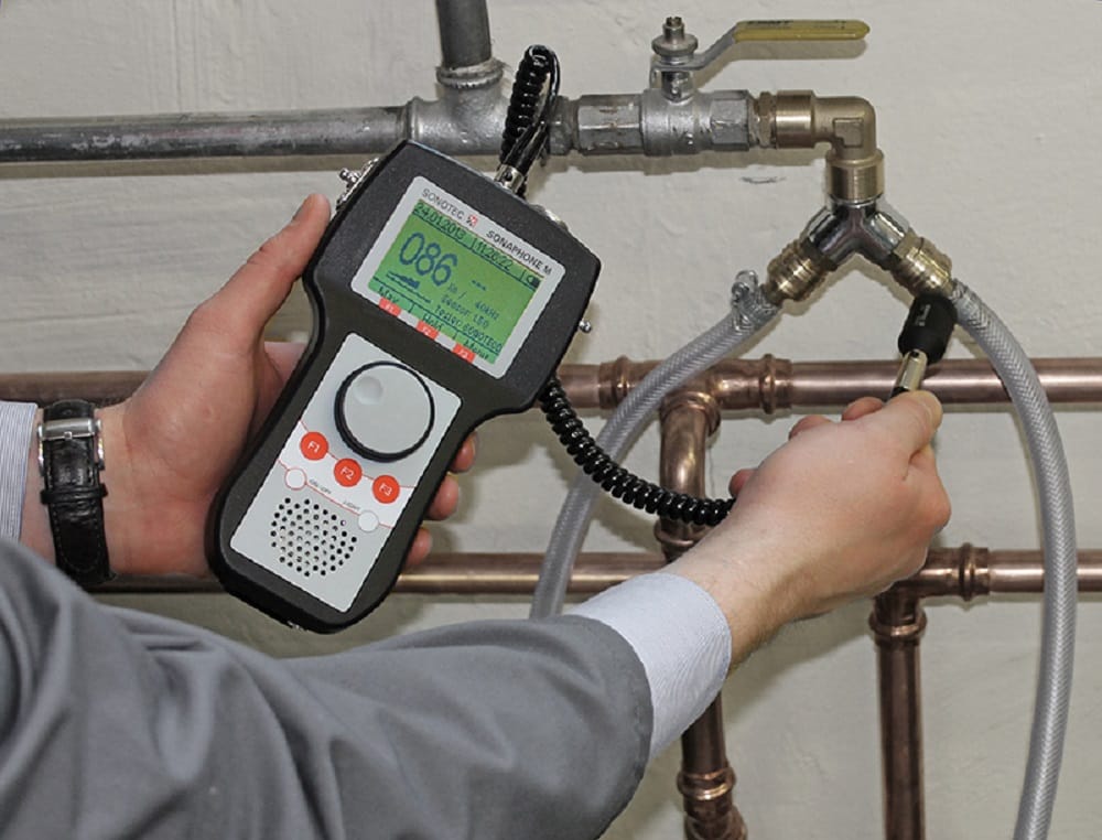 Plumber testing pipes with electronic leak detection equipment in Coconut Creek