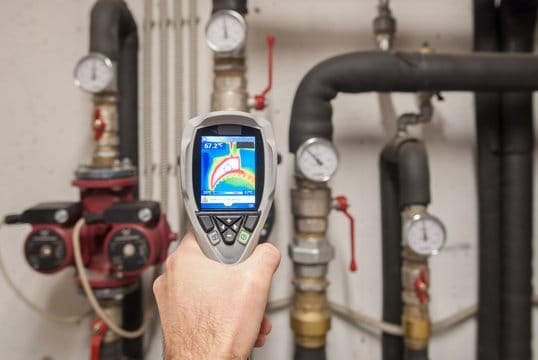 Plumber using a thermal imaging camera to inspect pipes in Coconut Creek