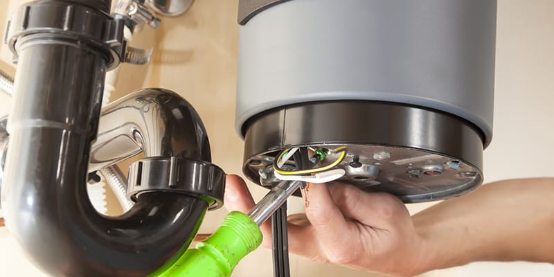 Technician repairing the heating element of a water heater in Coconut Creek
