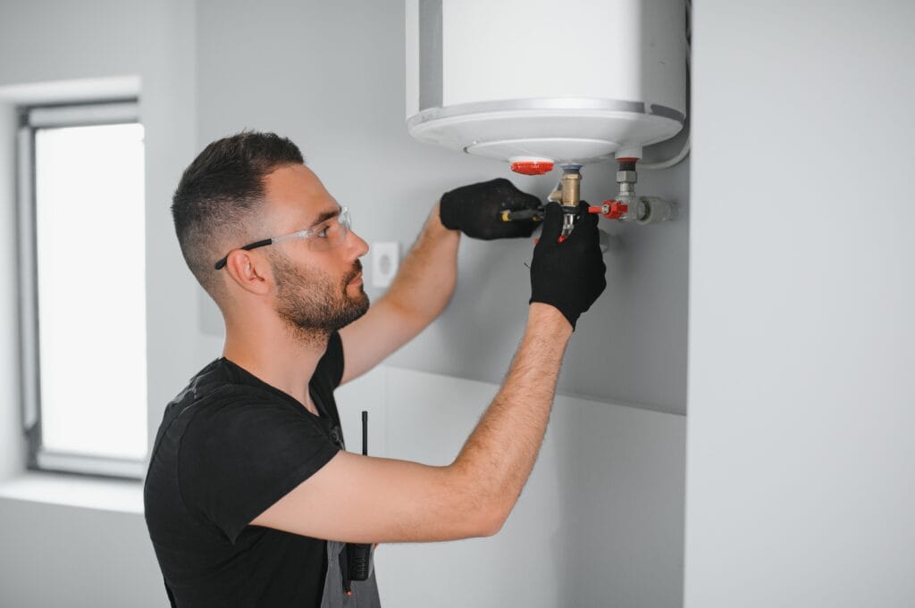 Technician performing water heater maintenance in Coconut Creek
