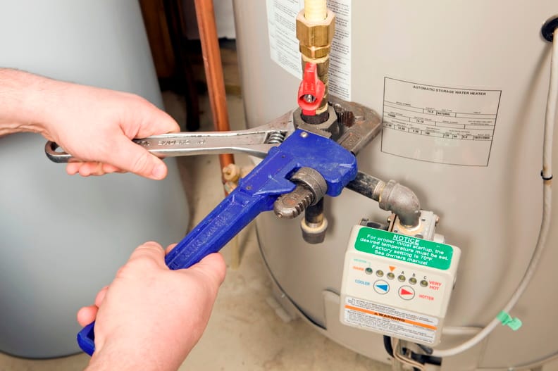Plumber repairing a water heater valve in Coconut Creek